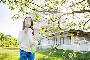 A little girl blowing soap bubbles with have fun and enjoyed on sunny days