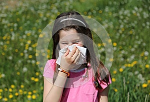 Little girl blows her nose with handkerchief