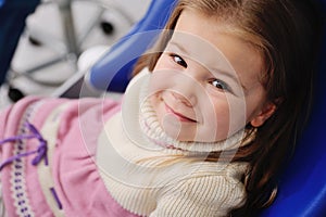 Little girl in a blue dental chair