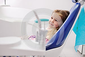 Little girl in a blue dental chair