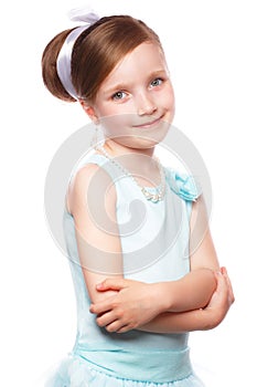 A little girl in a blue dress, with a retro hairstyle and accessories.