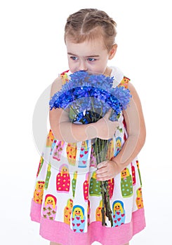 Little girl with blue flowers