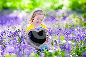 Little girl in bluebelss flowers