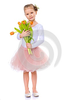 Little girl with a bouquet of tulips.