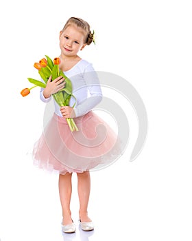 Little girl with a bouquet of tulips.