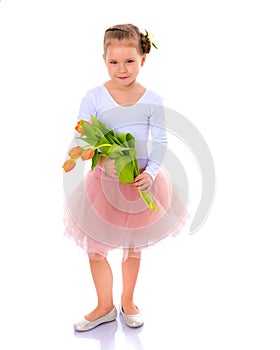 Little girl with a bouquet of tulips.