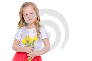 Little girl with a bouquet of tulips.