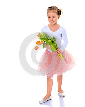 Little girl with a bouquet of tulips.