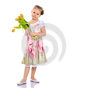 Little girl with a bouquet of tulips.