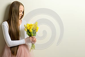 Little girl with a bouquet of tulips.