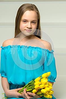 Little girl with a bouquet of tulips.