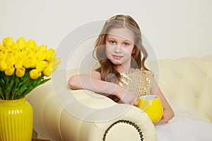 Little girl with a bouquet of tulips.