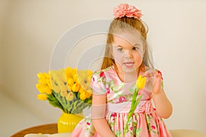 Little girl with a bouquet of tulips.