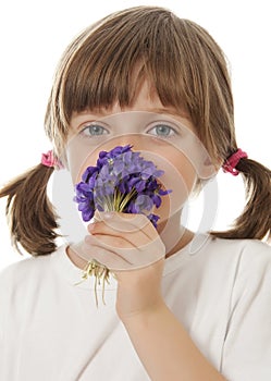 Little girl with a bouquet of violets