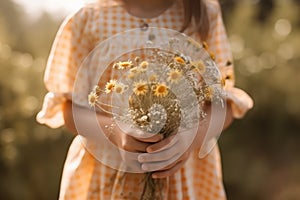 Little girl with bouquet of wildflowers outdoors, closeup, Midsection of a cute little girl without face holding flowers, AI