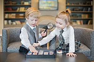 Little girl with boy in business clothes play with