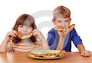 Little girl and boy eat pizza