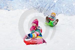 Kids play in snow. Winter sled ride for children