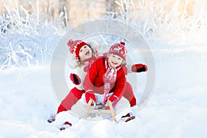 Kids play in snow. Winter sleigh ride for children