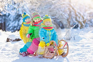 Kids play in snow. Winter sled ride for children