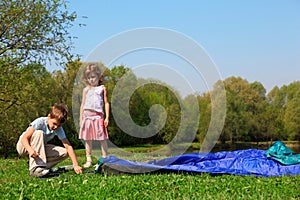 Little girl and boy making tent