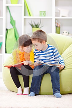 Little girl and boy reading