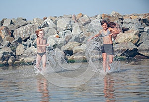 Little girl and boy in the sea