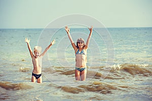 Little girl and boy in the sea