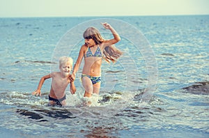 Little girl and boy in the sea