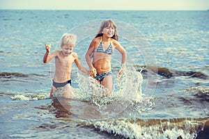 Little girl and boy in the sea