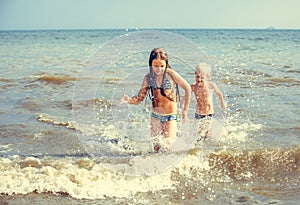 Little girl and boy in the sea