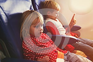 Little girl and boy travel by plane