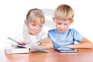 Little girl and boy using digital pad and book