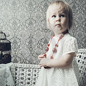 Little girl with bright red jewellery