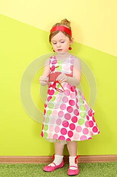 A little girl in a bright varicolored