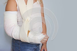 Little girl with broken arm, in plaster, with copy space