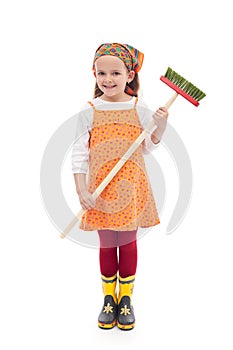 Little girl with broom and rubber boots