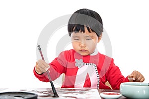 A little girl with a brush in her right hand and a seal in her left hand on a white background