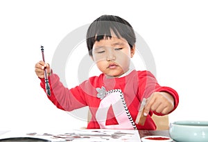 The little girl with brush in right hand and seal in left hand in white background