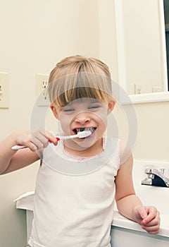 A little girl brushing her teeth