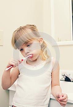 A little girl brushing her teeth