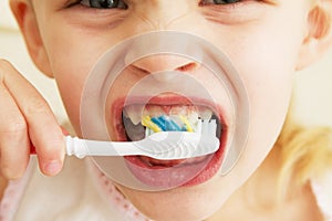 A little girl brushing her teeth