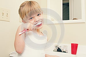 A little girl brushing her teeth