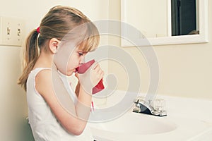 A little girl brushing her teeth