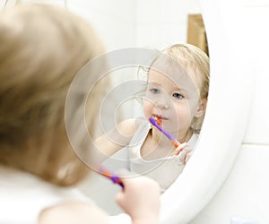 Little girl brushing her teeth