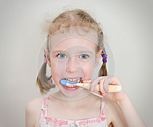 Little girl brushing her teeth.