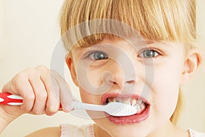 A little girl brushing her teeth