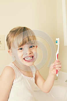 A little girl brushing her teeth