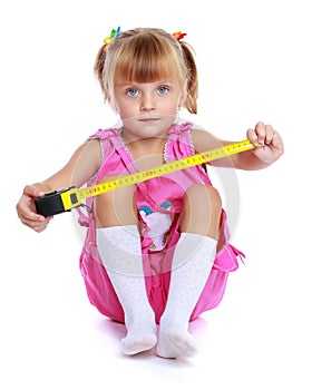 Little girl with a building tape measure.