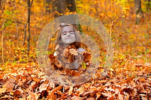 Little Girl Buried In Fall Leaves